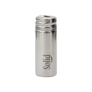 Stainless steel refillable dental floss container by Solid Oral Care. Silver in colour with the Solid logo etched onto the side.