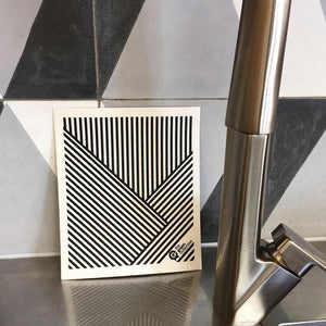 Dish cloth with stripes design and kitchen counter backdrop.