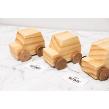 A row of wooden toy cars handmade with care from reclaimed Rimu and sustainably sourced Pine timber.